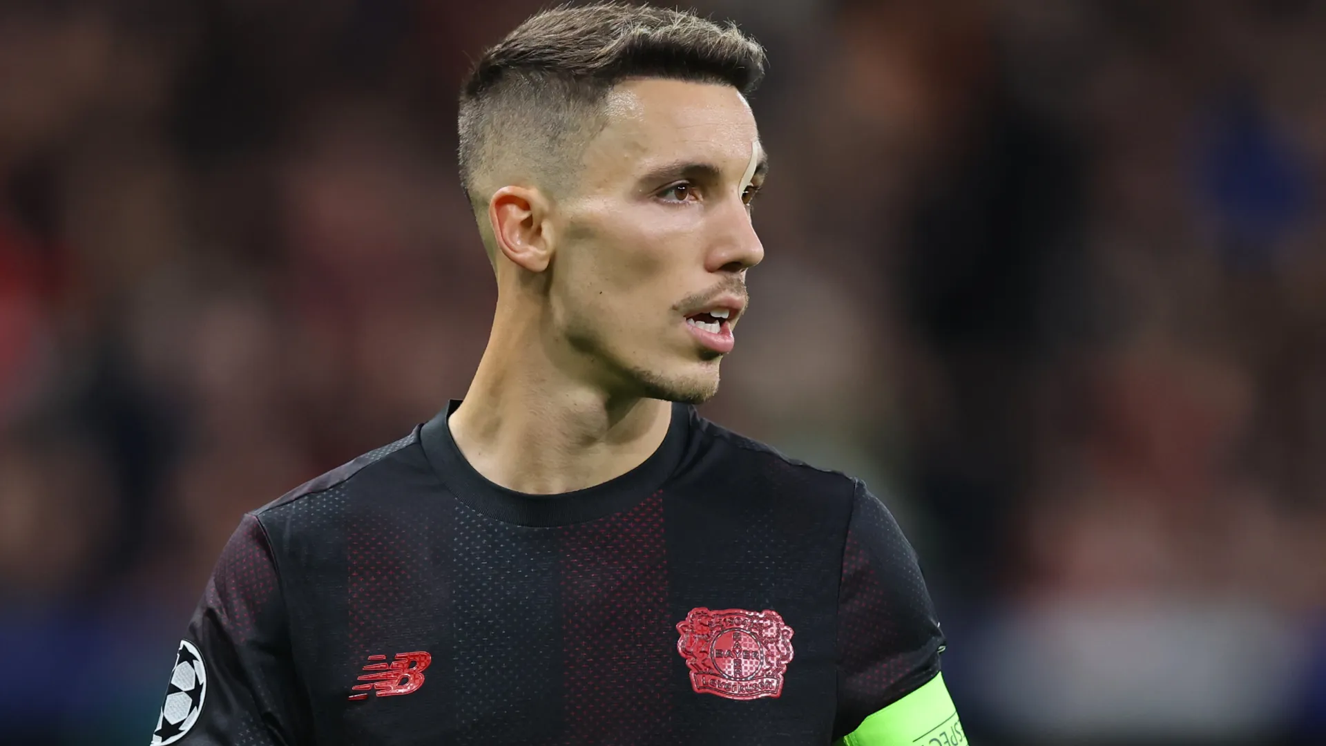 Grimaldo aparece olhando para o lado durante uma partida do Bayer Leverkusen.